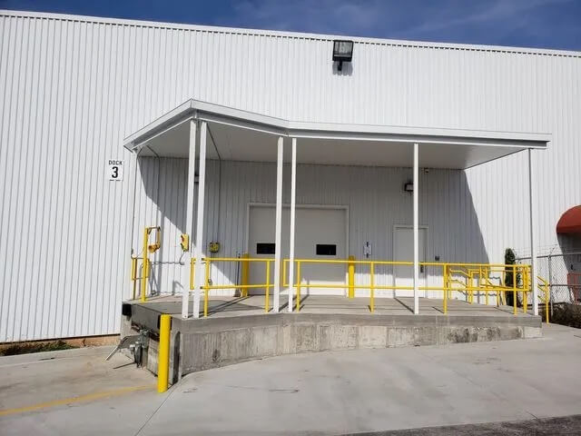 Loading dock with yellow railings and overhead cover.