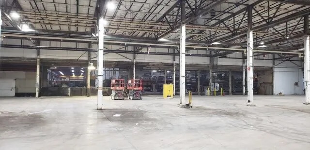 Spacious empty industrial warehouse interior with pillars