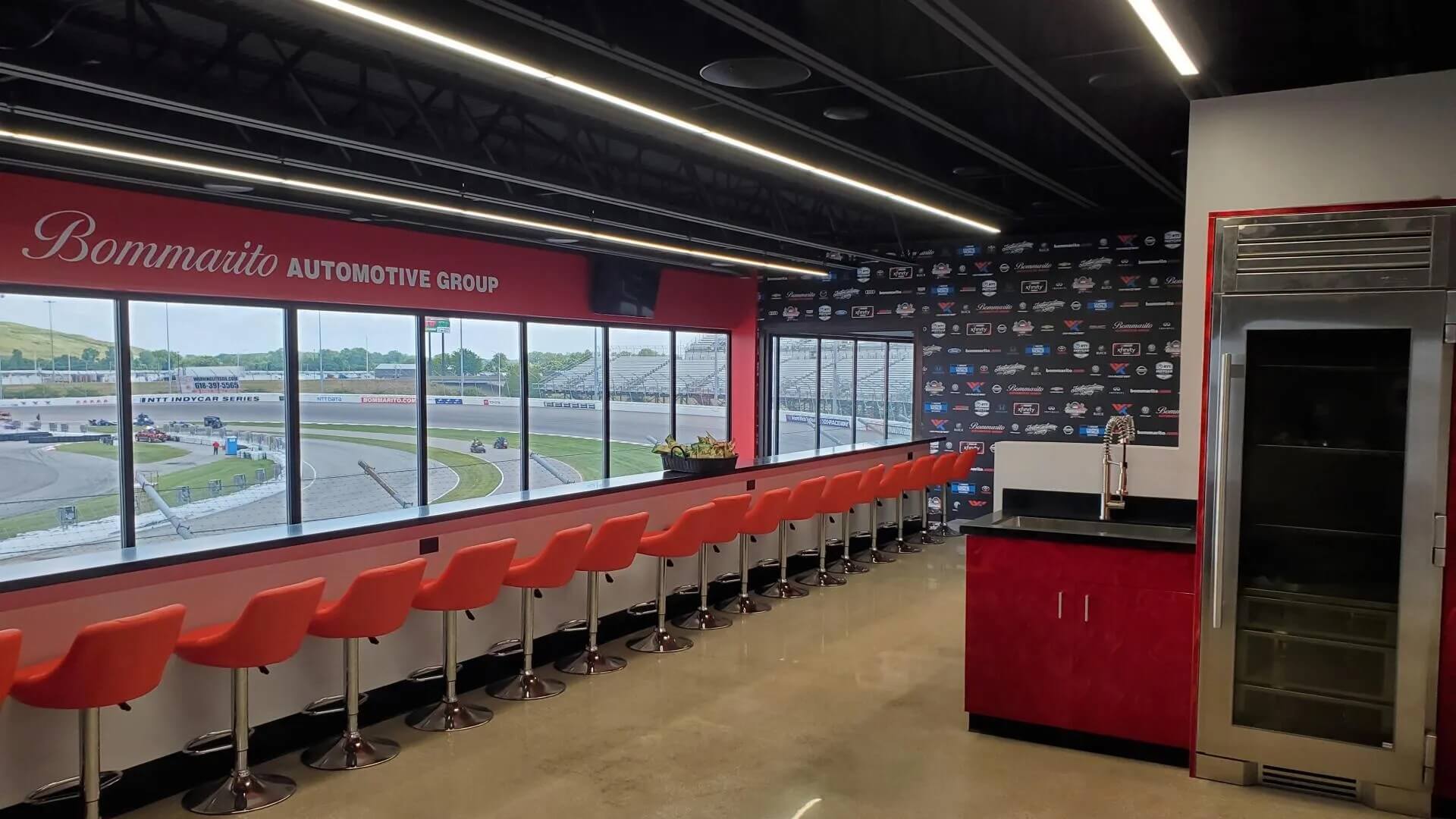 Luxury trackside lounge with orange bar stools.